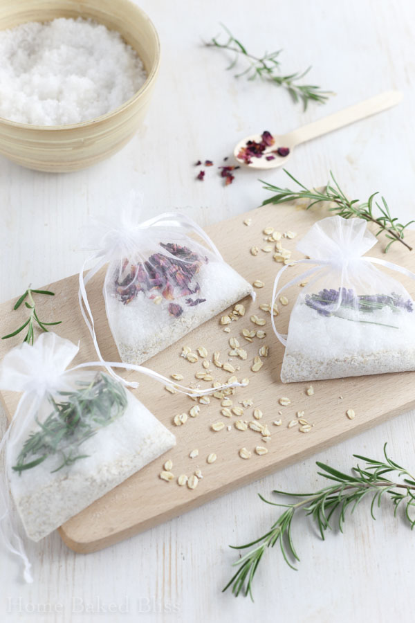 Tub tea sachets on a white background next to a bowl of salt and fresh sprigs of rosemary.