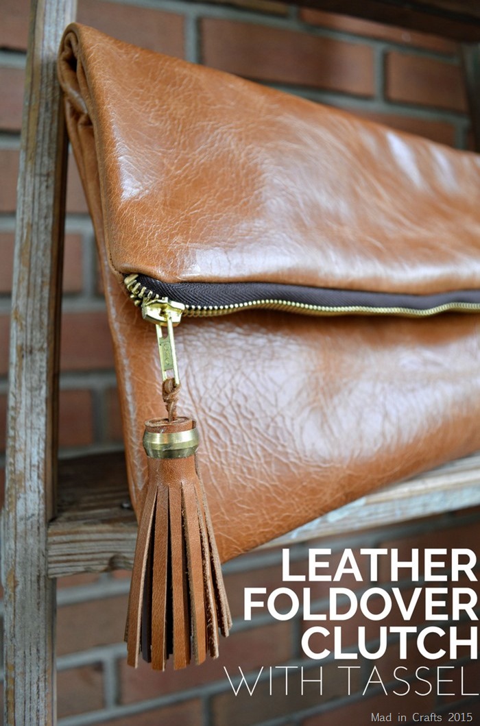 Close up of a leather foldover clutch with a tassell