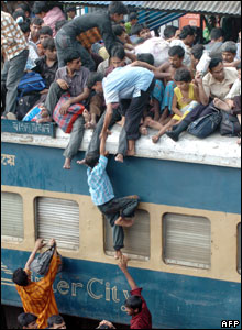Homebound people crowd to board a passenger train in Dhaka, Bangladesh