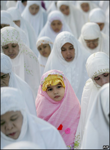 A Muslim girl takes part in a morning prayer marking the start Eid al-Fitr in Jakarta, Indonesia