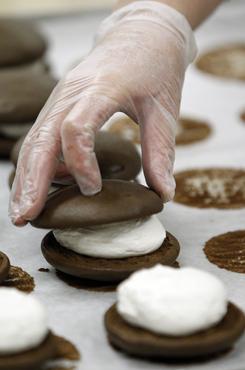 A baker makes whoopie pies at the S. Clyde Weaver market in East Petersburg, Pa.