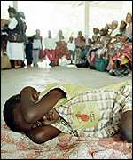 Child waits to be tested for malaria in Mozambique AP