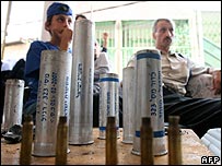Arab residents of Pekiin in northern Israel sit in front bullet and gas cases fired by Israeli police after riots in October 2007