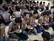 Rohingya eat after being arrested by the Thai authorities on an island in the Andaman Sea (27 January)