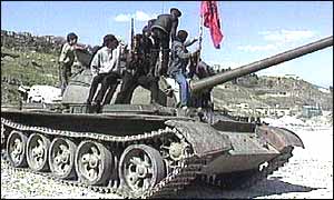 Albanian rebels on top of seized tank in 1997